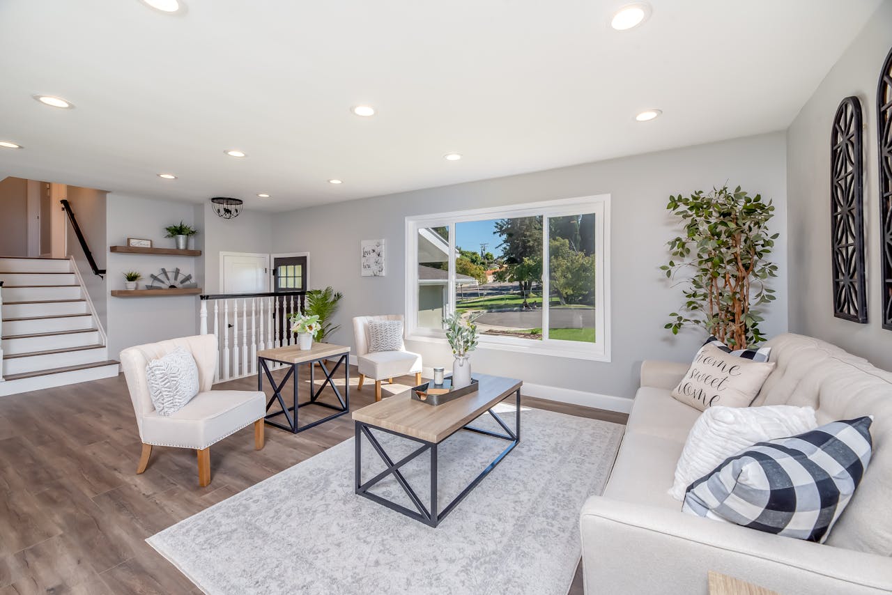 Contemporary living room with stylish furniture and a large window offering a scenic view.